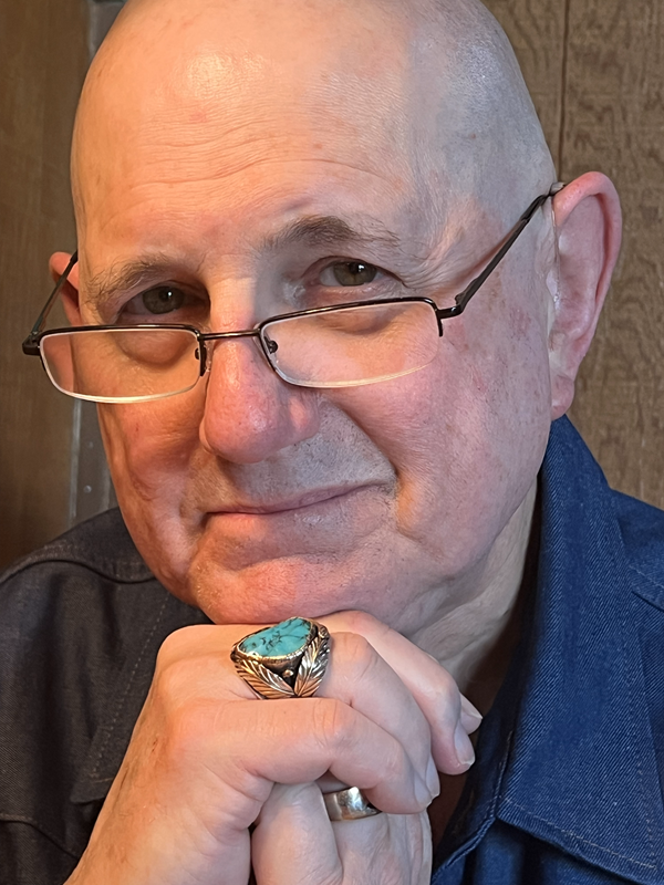 Barry Nickelsberg, head shot with Barry's chin resting on hands. He is wearing a large turquoise ring.